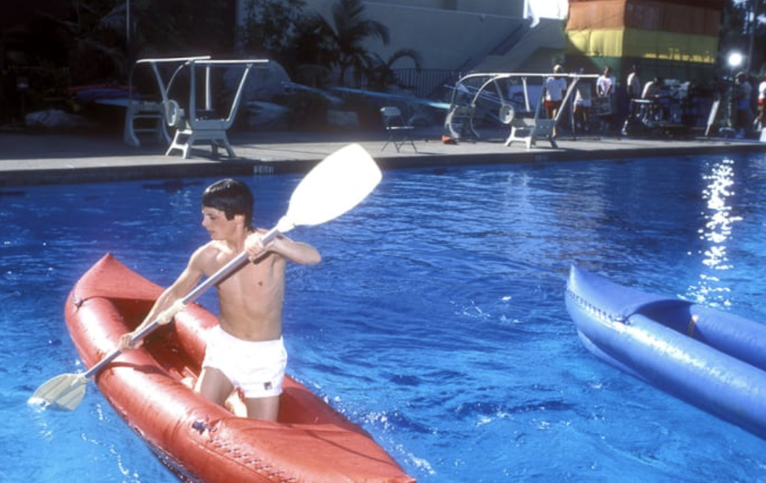 Michael J. Fox paddles a kayak, 1984. 